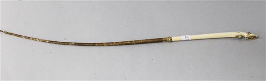 A gold mounted ivory horse hoof riding crop